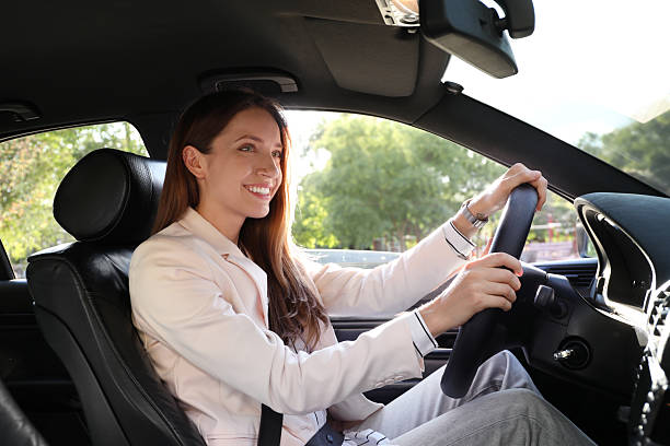istock Woman holding steering wheel while driving car 2214774077