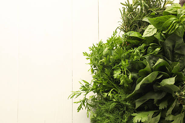 istock Different fresh herbs in basket on white wooden table, top view. Space for text 2214775613