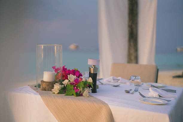 istock Table setting at restaurant on edge of sea 2214776745