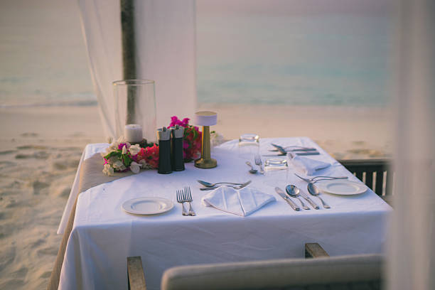 istock Table setting at restaurant on edge of sea 2214776751