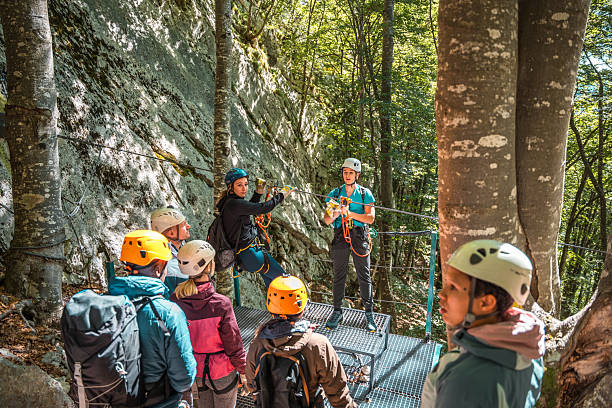 istock Young Experienced Zipline Coach Demonstrating Finesse And Skill Ensuring Each Participant Feels Empowered And Ready For Exhilarating Flight 2214778058