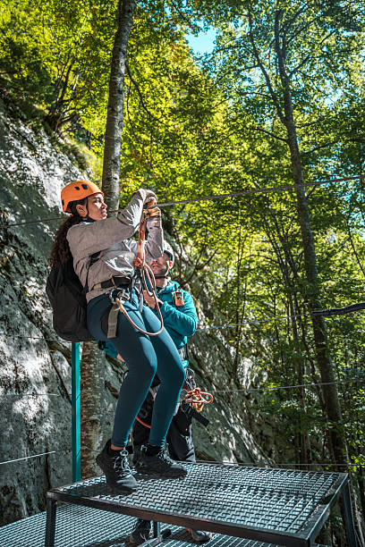 Happy Young Black Female Getting Ready To Start Zipline Adventure Through A Tranquil Forest And Embracing Nature's Beauty