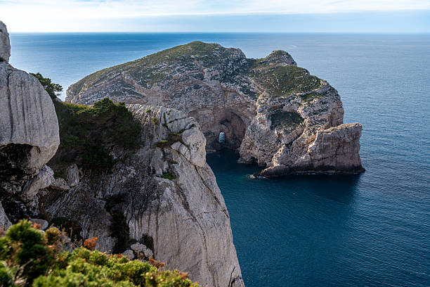 istock Coastal cliffs with sea cave opening at Capo Caccia 2214779009