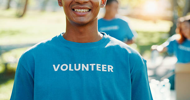 istock Volunteer, smile and helping with man in park for recycle program, earth day or social responsibility. Environment, climate change and ngo with person in nature for non profit, cleaning or charity 2214779113
