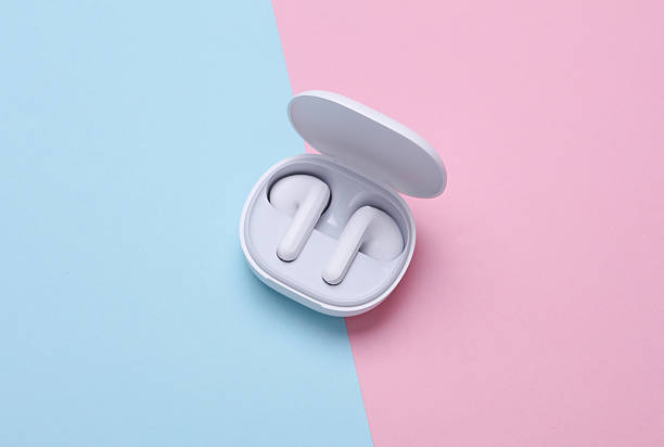 istock Wireless earphones with charging case on blue pink background 2214787336
