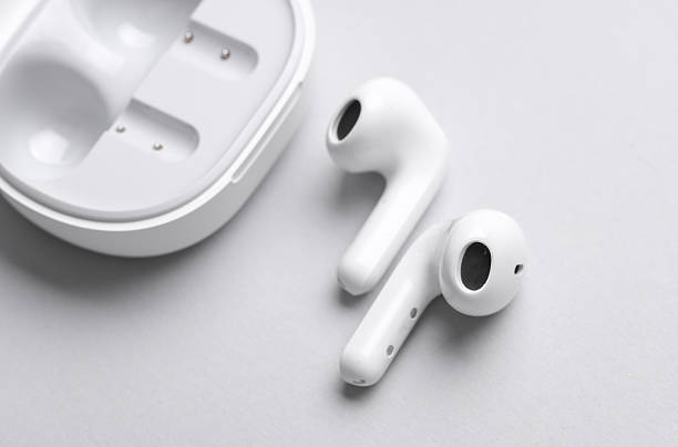 istock Wireless earphones with charging case on gray background. 2214787383