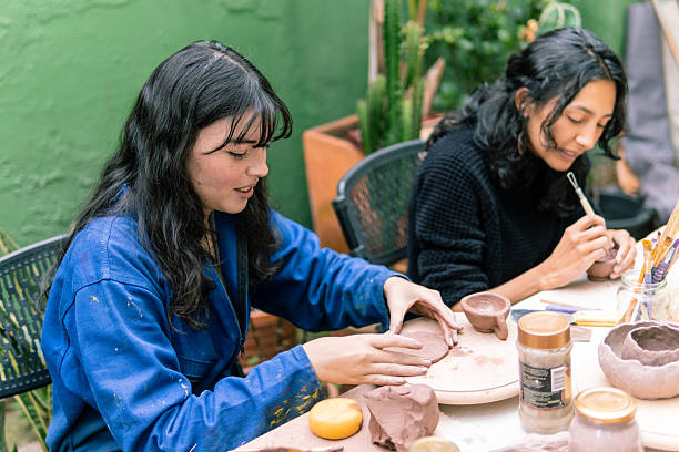 istock Women molding clay creating pottery in a workshop 2214791325