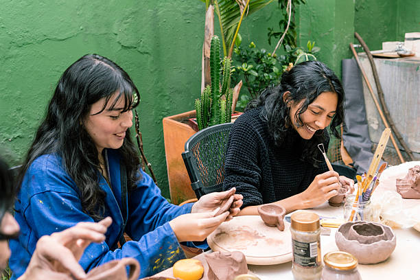 istock Women creating pottery in workshop smiling and enjoying their work 2214791779