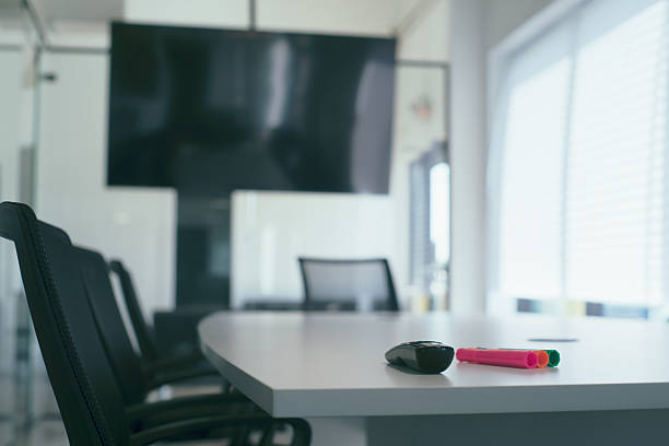 Empty conference room ready for presentation with markers and remote