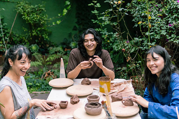 istock Young ceramists enjoying pottery workshop in a garden 2214793160