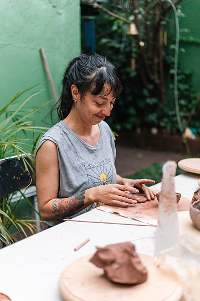 istock Woman making pottery outdoors enjoying her hobby 2214793414