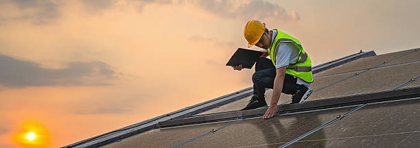 istock man in a yellow safety vest is looking at a laptop while standing on a roof 2214798719