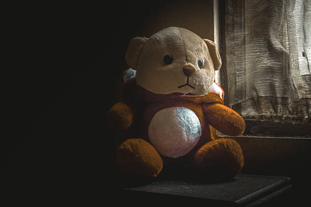 istock teddy bear in the dark, teddy bear in low light 2214805772