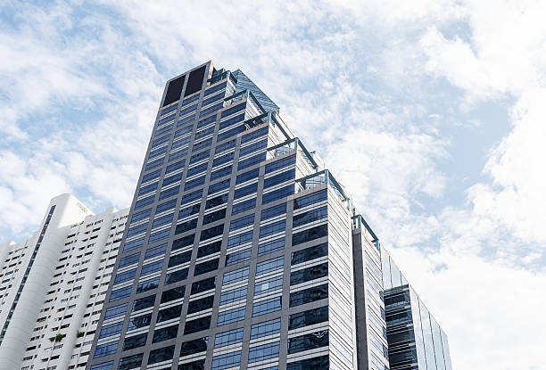 istock Bottom up view tower building with blue sky background 2214806301