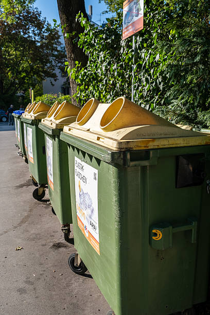 Munich - Germany, December 17,  2017: Public recycling garbage collection point in Munich. Plastic, sheet metal, cans and glass are collected in containers at many collection points in the city and transported from there to recycling points. If the glass containers are full, more bottles are often placed next to the containers.
