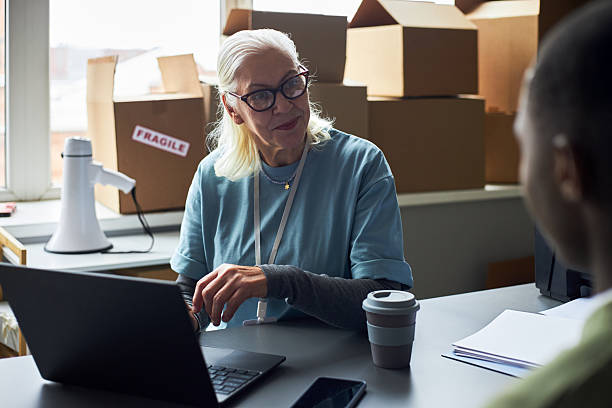 istock Elderly Woman Working in Office with Laptop Computer 2214806444