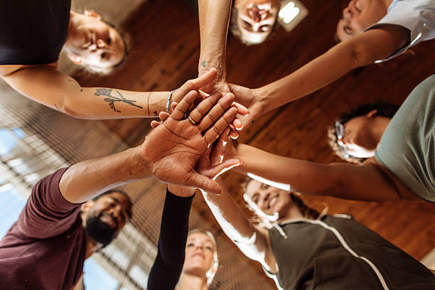 istock Bottom view of basketball team stacking hands 2214806513