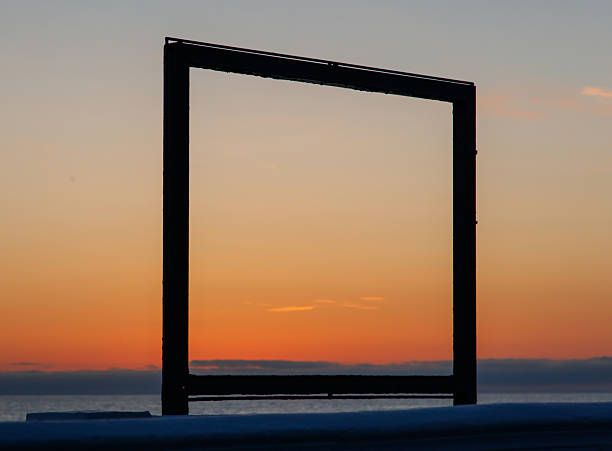 istock A large, empty frame is set against a backdrop of a beautiful sunset 2214806604