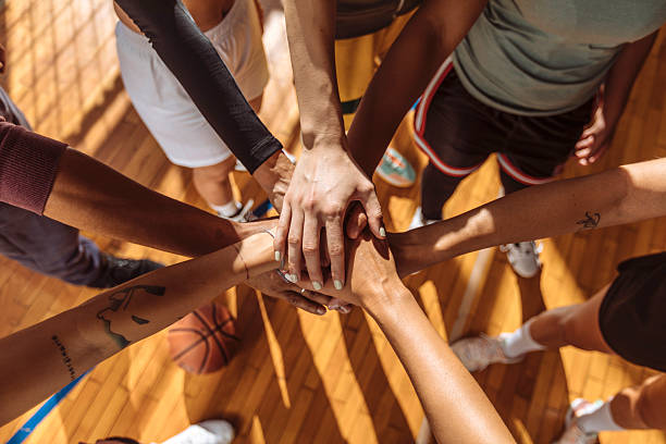 istock Close up of basketball team stacking hands 2214806719