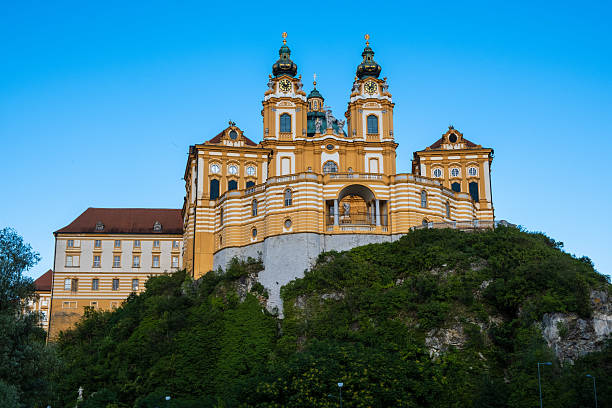 Melk, Austria- August 16, 2019:  View of the historic Melk Abbey from Danube river at sunset