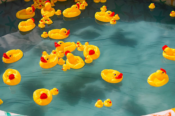 istock Many rubber yellow toy ducks floating in children's pool 2214809685