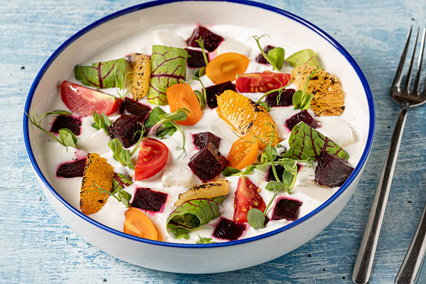 istock Colorful yogurt salad with grilled oranges, beets, cherry tomatoes, and greens 2214809742