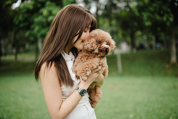 istock Pet Love: Smiling Woman and Her Fluffy Dog 2214811020