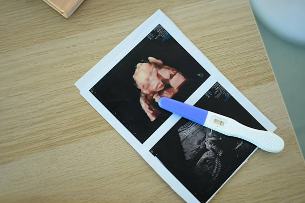 istock 3D and 2D ultrasound pictures with a pregnancy test. Fetal development concept. 2214811527