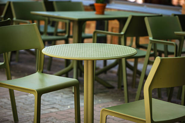 istock Empty plastic chairs and tables in a street cafe early morning, table for two close-up. 2214812079