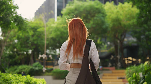 Young asian professional browsing her smartphone.