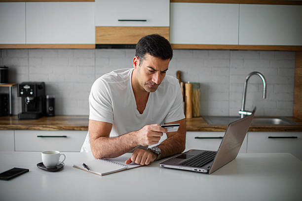 istock Man working on his financial bills at home in kitchen 2214816047