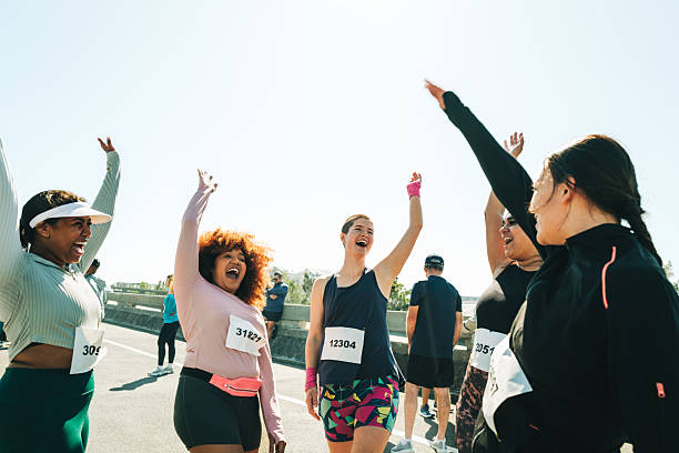 istock Ladies celebrating at a community running event 2214816212