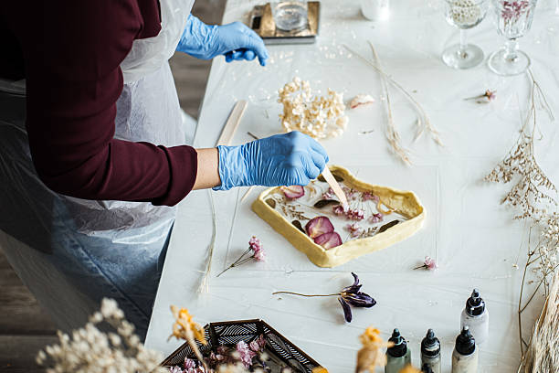 istock Crafting resin art with dried flowers, step-by-step process for beginners. Hands-on DIY home decor with natural elements, sustainable techniques. 2214816769