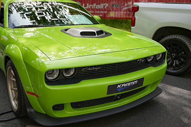 Germany Berlin May 11, 2025. Green Challenger Front View. Front view of a striking, bright green Dodge Challenger with a typical retro look.