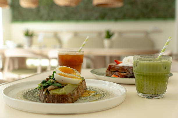 Healthy avocado toast with boiled egg, matcha latte and french toast enjoying a modern restaurant