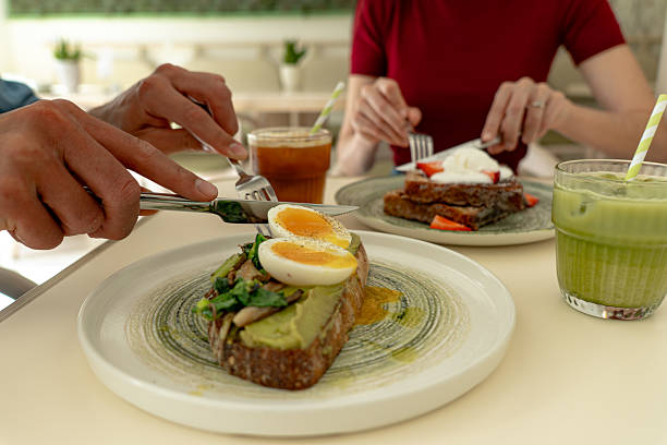 istock Customer enjoying avocado toast with boiled eggs and matcha latte in cafe 2214821092
