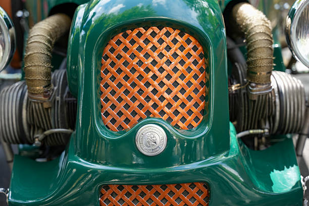 A vintage truck painted bright green displays its polished horn under the sun at an outdoor gathering, highlighting its classic design and attention to detail for enthusiasts and passersby.