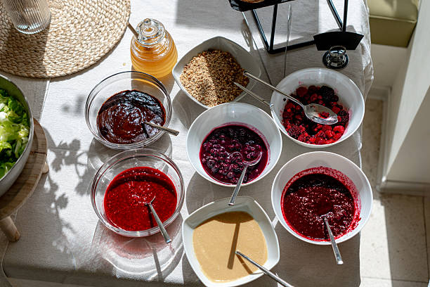 Colorful breakfast buffet offering various jams, berries, honey and nuts, catering or hospitality concept