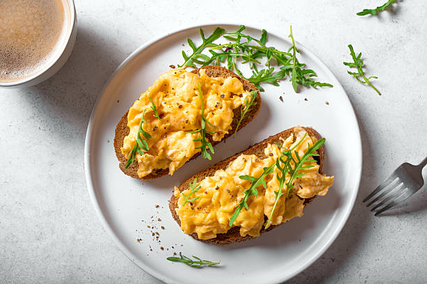 istock Scrambled Eggs sandwiches and cup of coffee for breakfast 2214821942