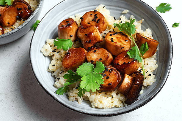 istock Fried teriyaki eryngii mushrooms with rice 2214822355