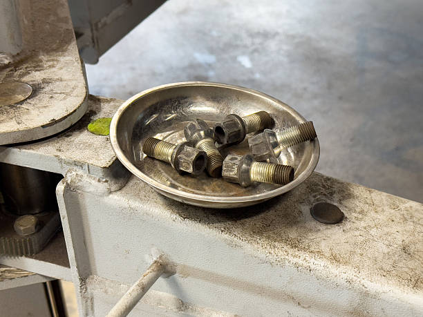 istock Metal tray with hex flange lug nuts on industrial metal surface 2214822931