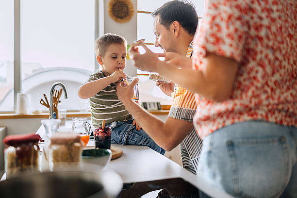 istock Family enjoying breakfast in the kitchen 2214828466