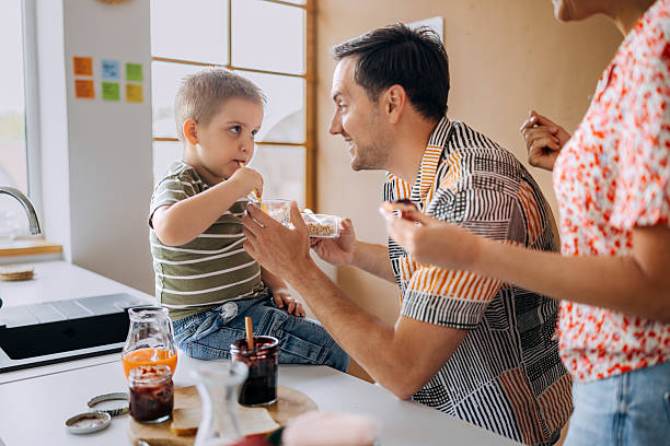 istock Family enjoying breakfast in the kitchen 2214828482