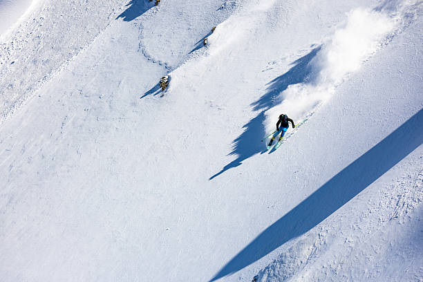 istock Back country skier riding on steep terrain 2214828736