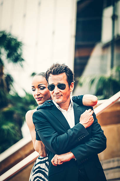 Celebrity couple on red carpet of film festival in Cannes.