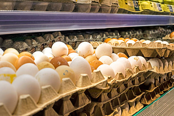 chicken white and brown eggs in a cardboard container in the supermarket