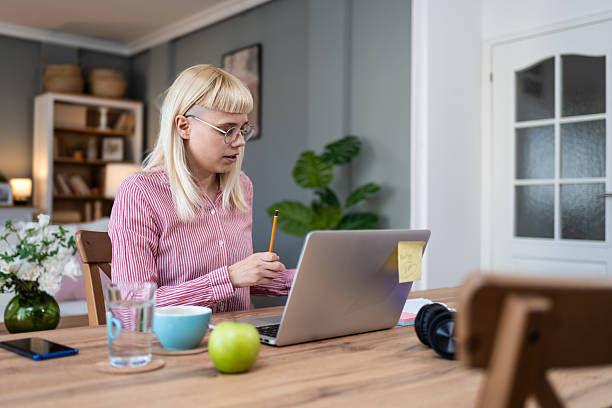 istock Young freelance business woman having video call conference on laptop computer while sitting and working at home, talking on webcam with potential investor in her project. Finance and economy concept. 2214833959