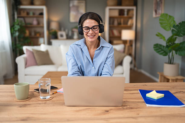 istock Young freelance business woman having video call conference on laptop computer while sitting and working at home, talking on webcam with potential investor in her project. Finance and economy concept. 2214833977