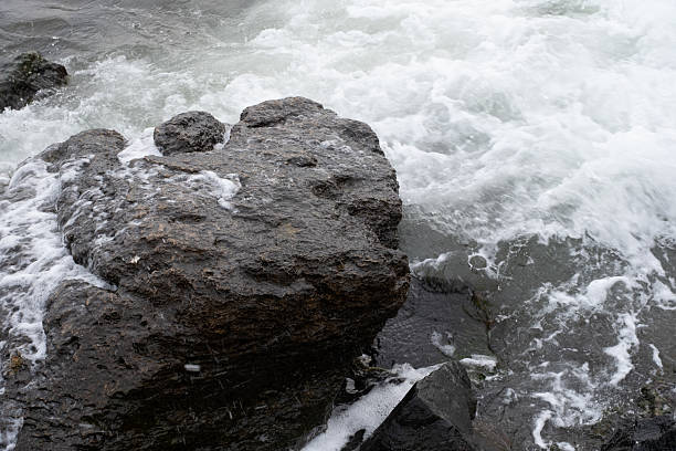 istock Ocean Waves Crashing Against Dark Coastal Rocks 2214834068