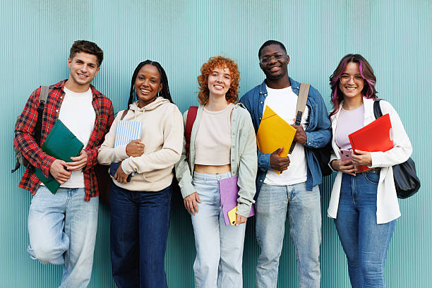 istock Happy multiethnic students standing against a turquoise wall 2214834785